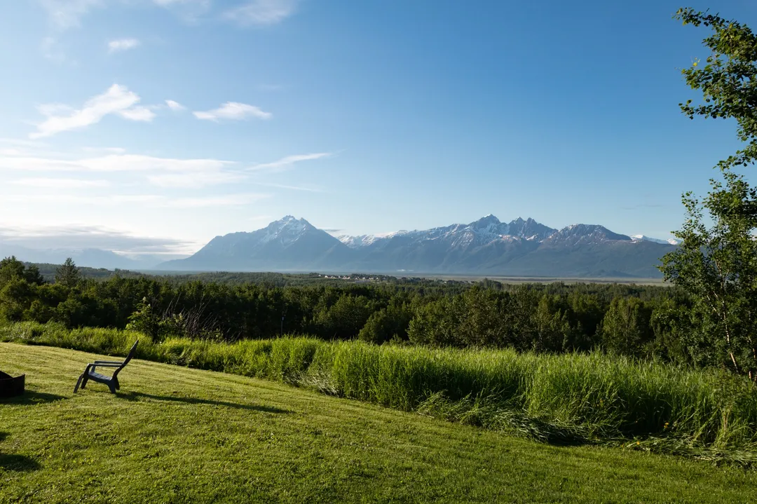 chairs around firepit facing mountains